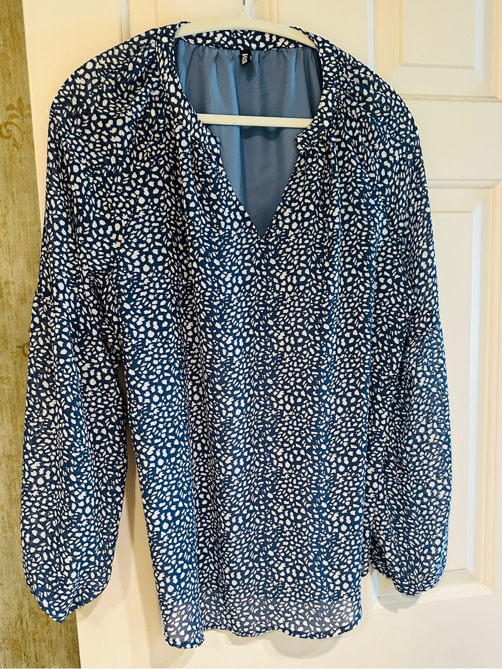 Transitional, flowy, blue and white “animal print” blouse